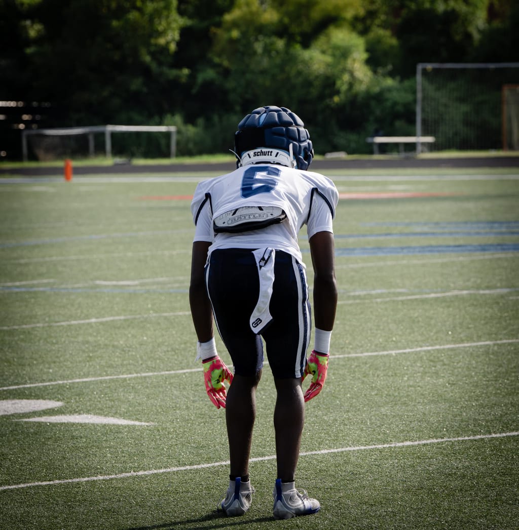 Defensive back set at the line, hands low