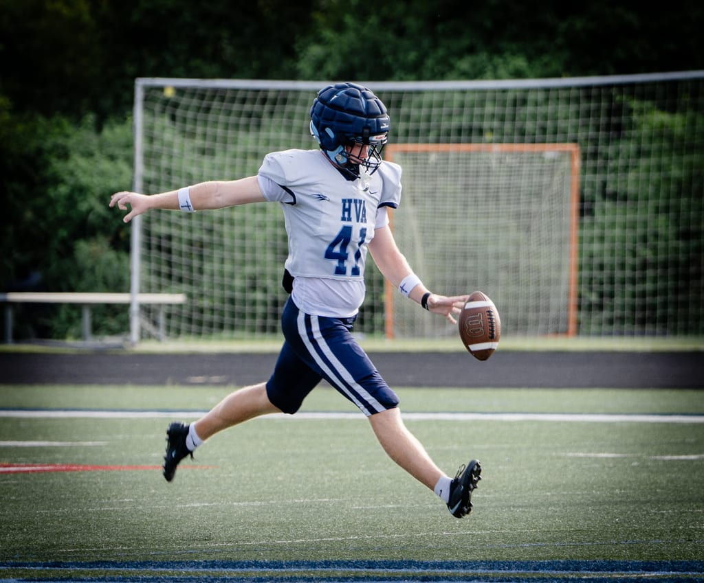 Punter striking the ball in full stride
