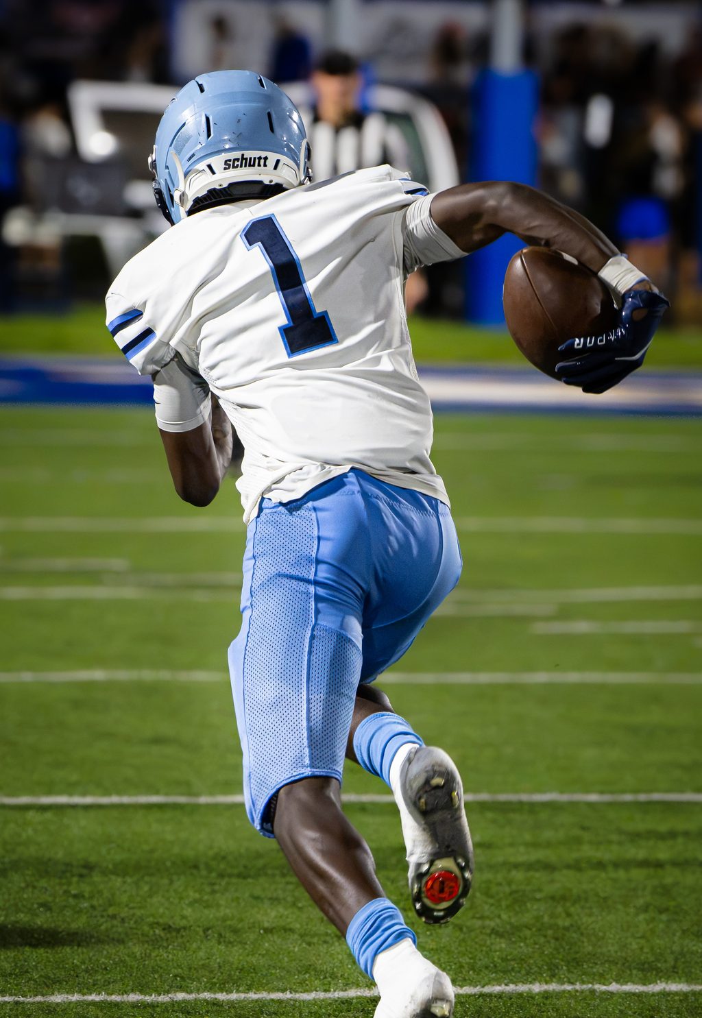 Ball carrier running upfield with the ball secured