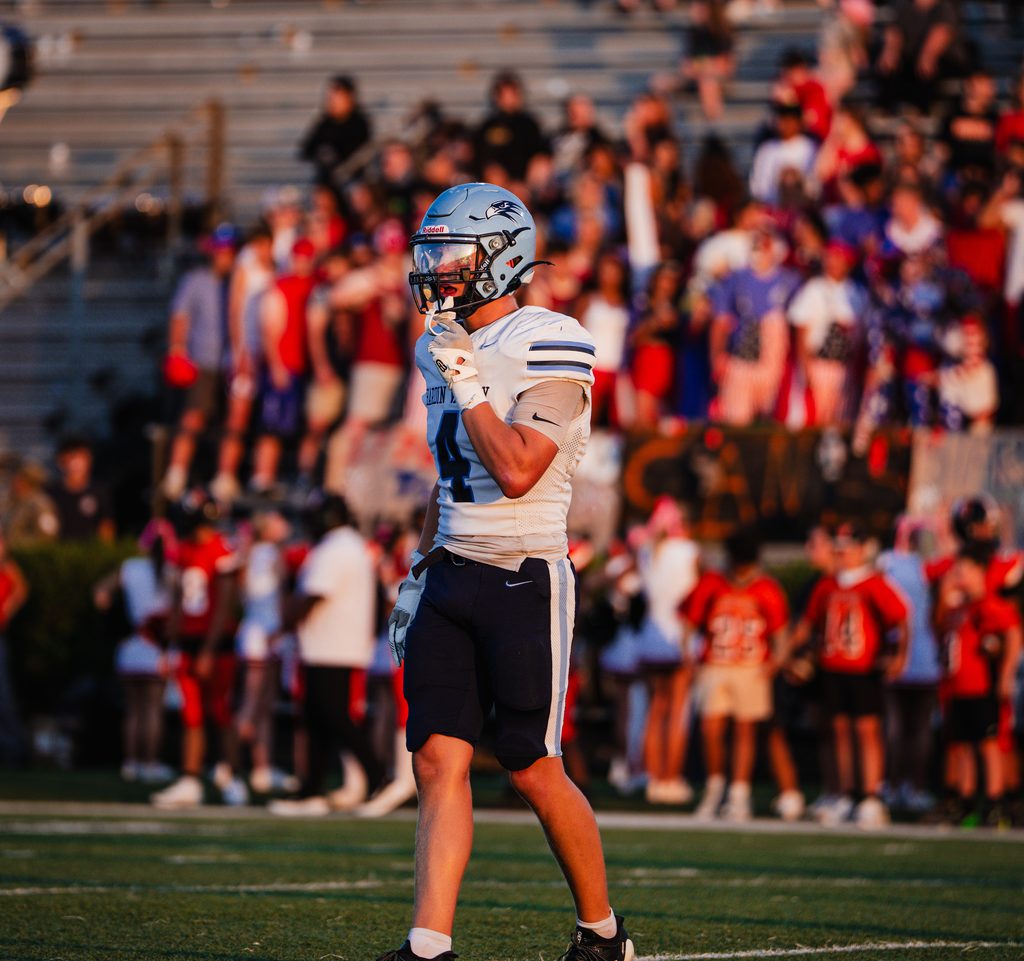 Player walking back as the crowd rises behind