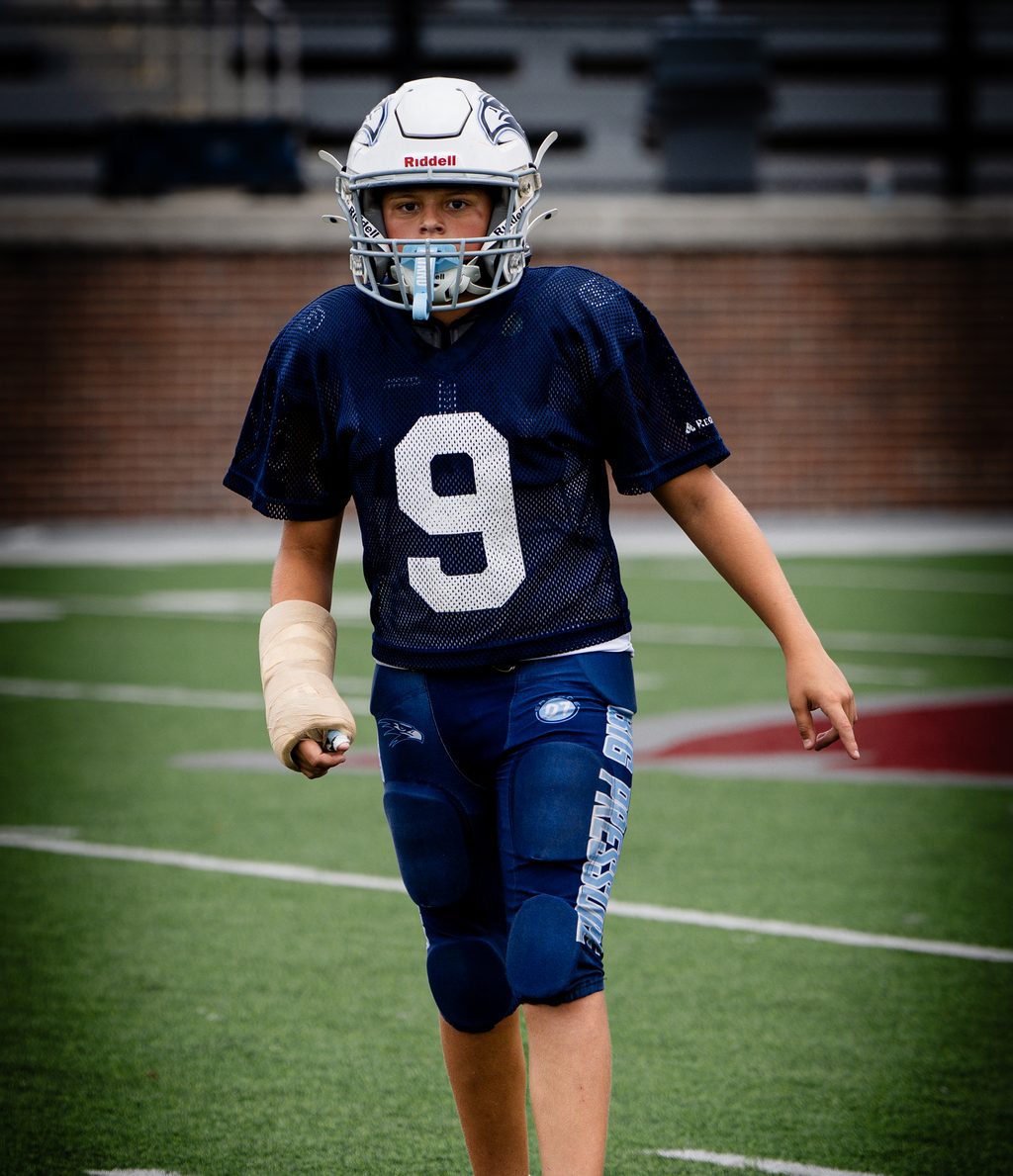 Young player walking back across the field